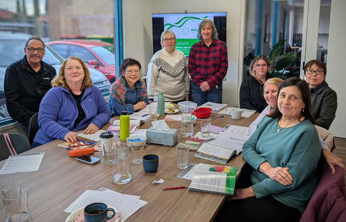 A diverse group of participants engaged in a MindSpark mental health first aid training workshop.