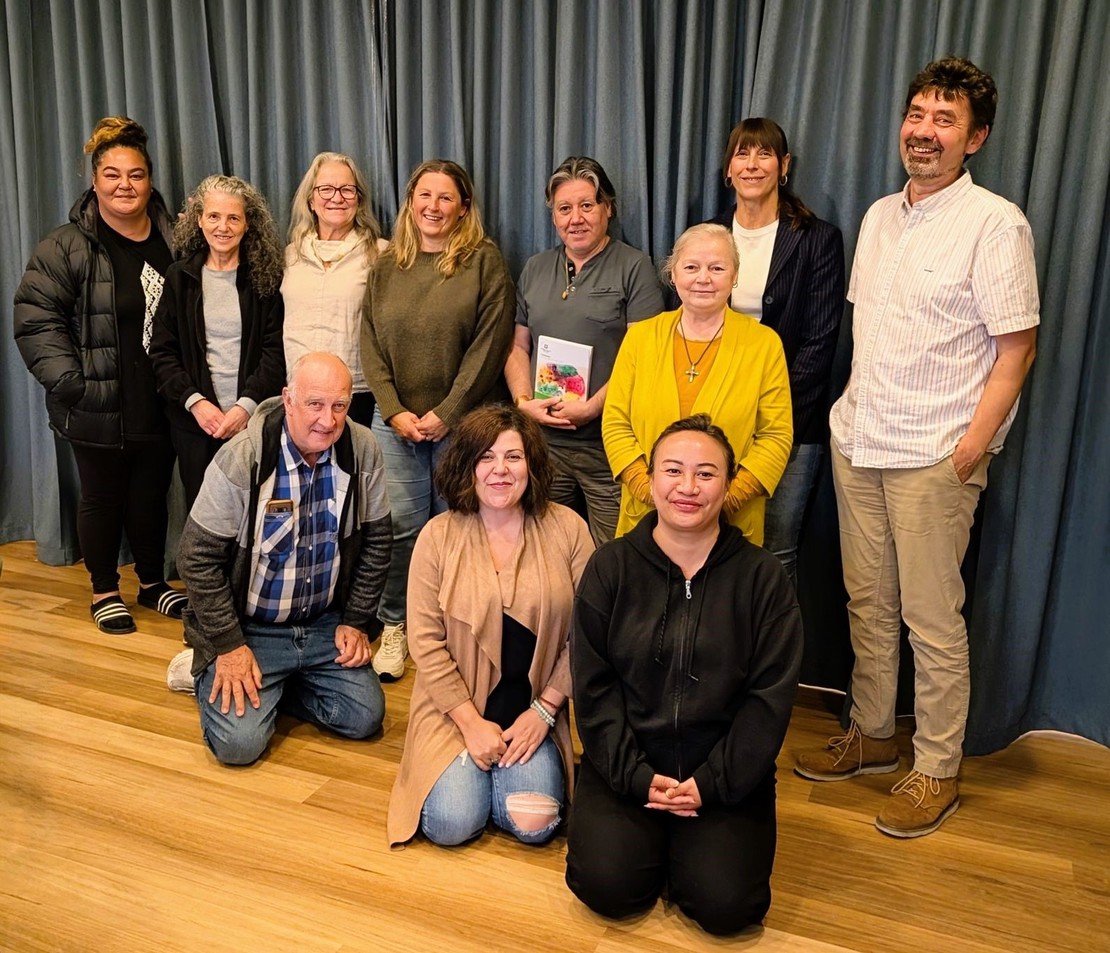 A photo of a MindSpark community group during a mental health first aid workshop, representing the types of groups that can book a private course.