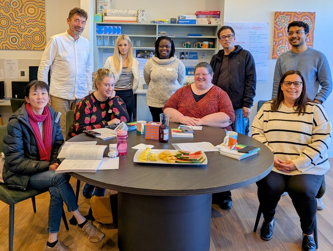 A photo of a MindSpark workplace group engaged in a mental health first aid workshop, representing the types of teams that can book a private course.